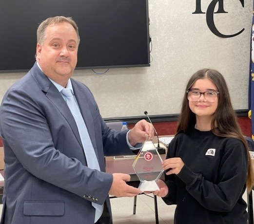 Superintendent Brett Johnson presents an award to GSA graduate Bailey Dunn.