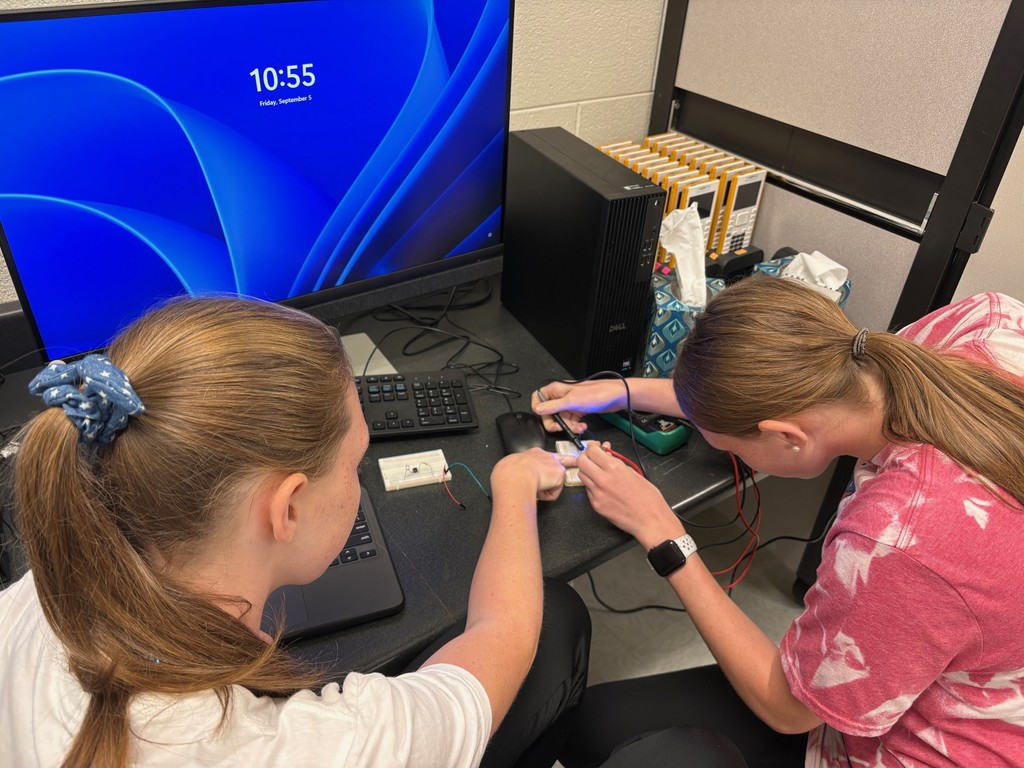 Students in Mrs. Rich’s Engineering 2 class are seen building electrical circuits on breadboards.