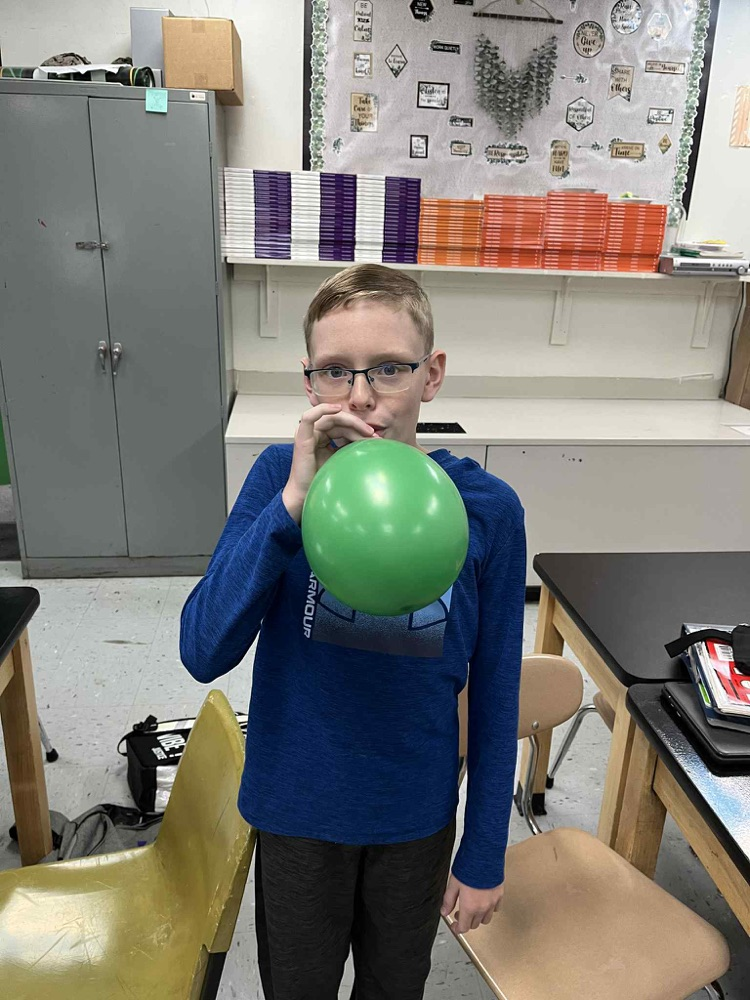 6th grade is demonstrating Newtons 3rd law motion using balloon rockets.