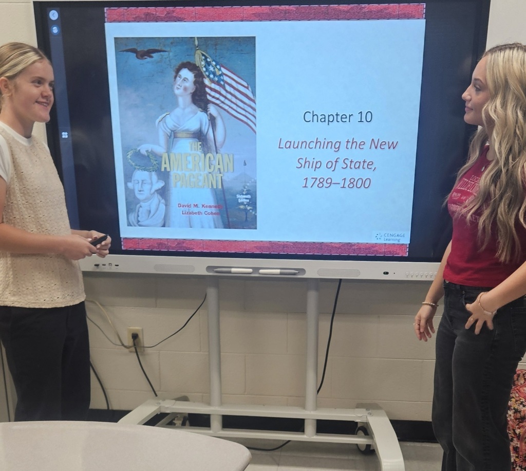 Harlan County High School dual credit history students Riley Duff and Savannah Hill present a lesson on the Constitution for Constitution Day.