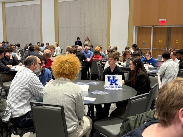Elijah Moore and Shania Middleton present t heir projects to a participating engineer. 