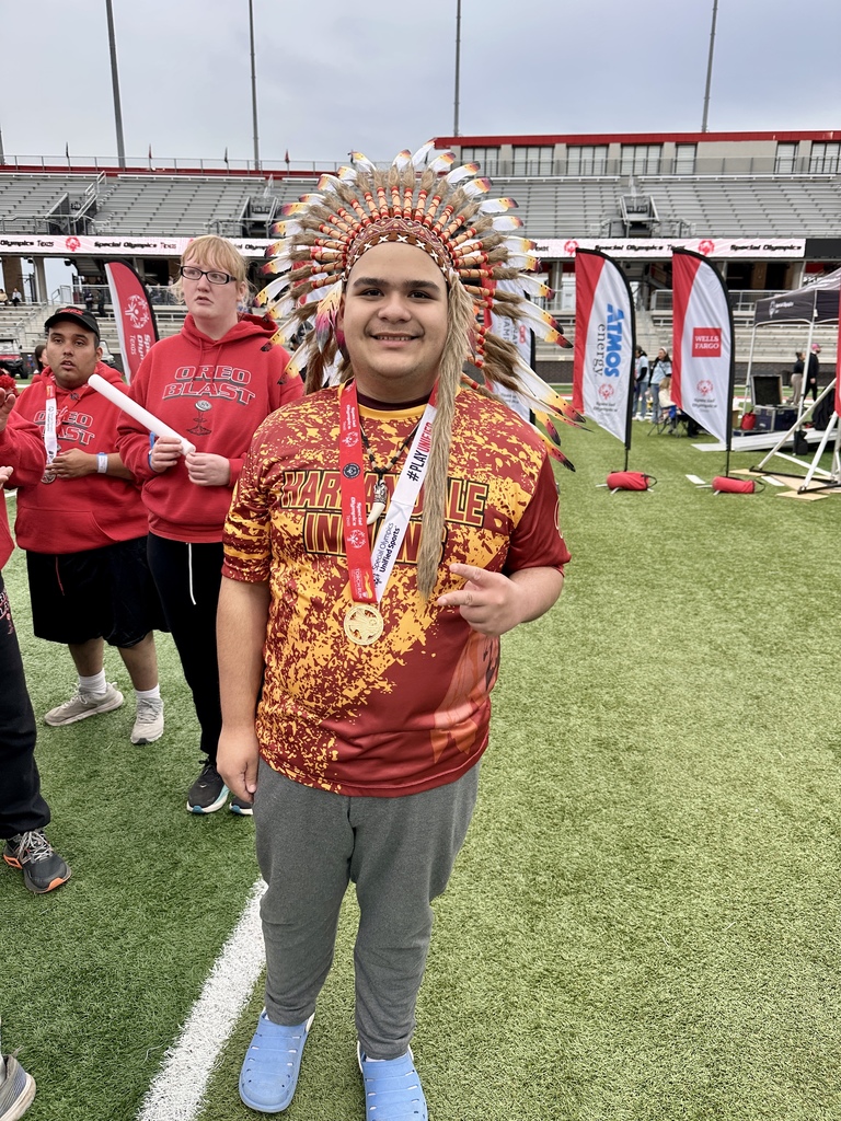 Marco on the field wearing his medal.