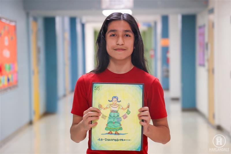 photo of student holding his artwork