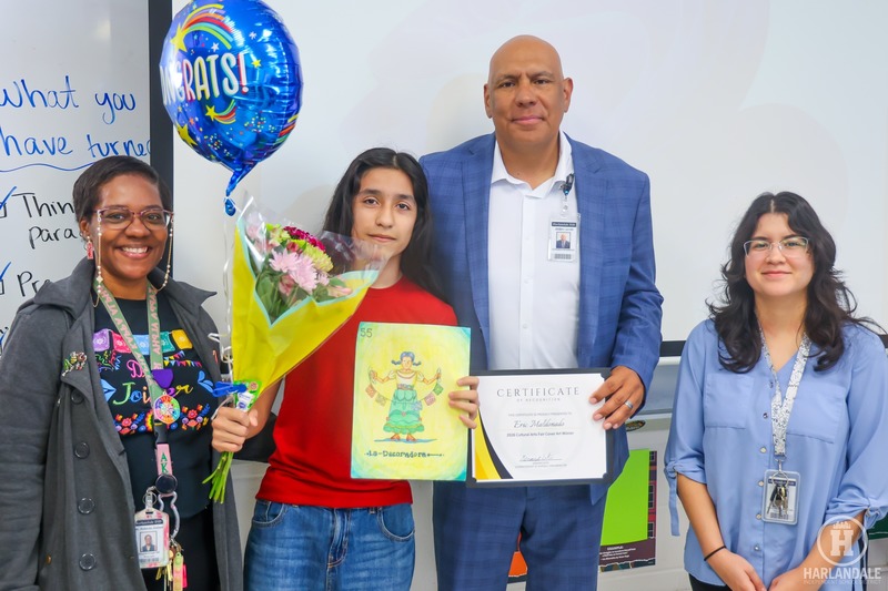 group photo of student holding artwork