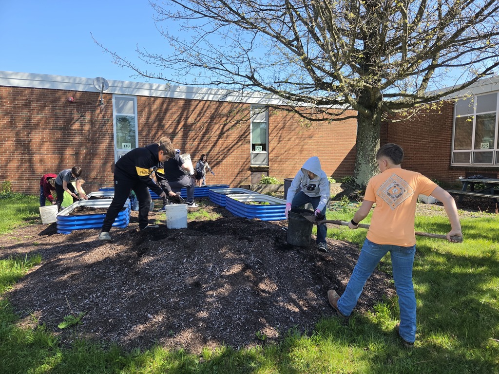 The 6th grade science/social studies class spent some time weeding, moving mulch and planting the garden beds.