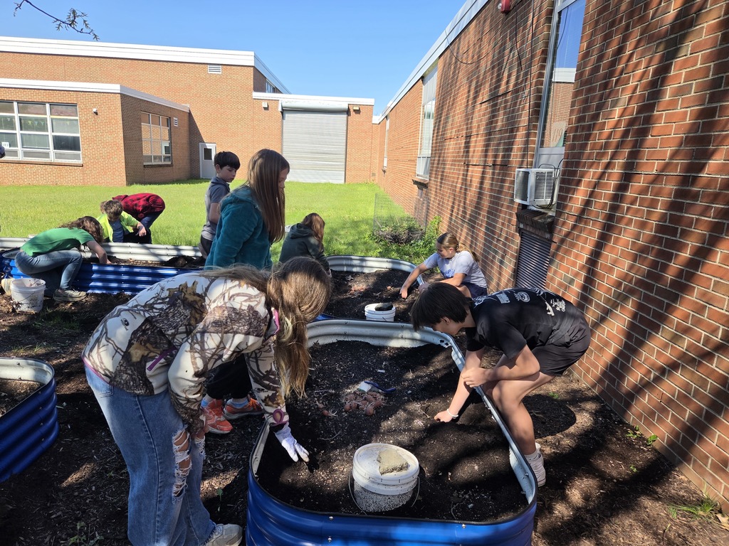 The 6th grade science/social studies class spent some time weeding, moving mulch and planting the garden beds.