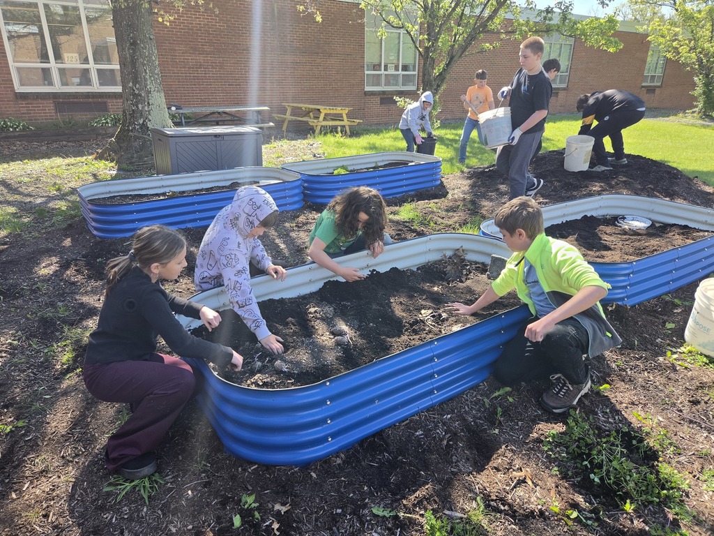 The 6th grade science/social studies class spent some time weeding, moving mulch and planting the garden beds.