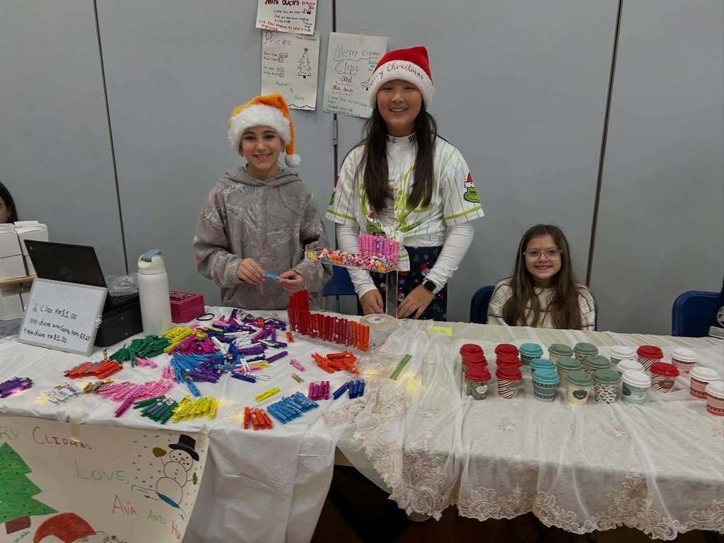 Students pose with their entrepreneurial projects that they sell at the TREPS Marketplace.