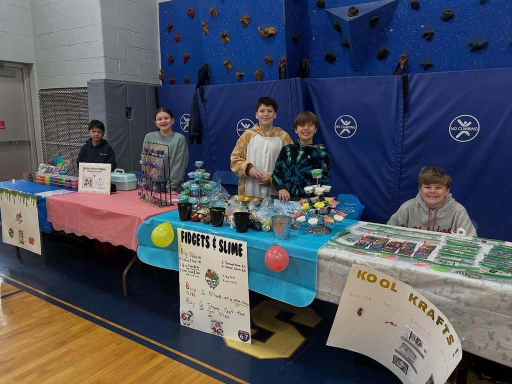 Students pose with their entrepreneurial projects that they sell at the TREPS Marketplace.