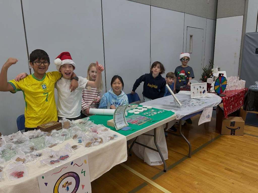 Students pose with their entrepreneurial projects that they sell at the TREPS Marketplace.