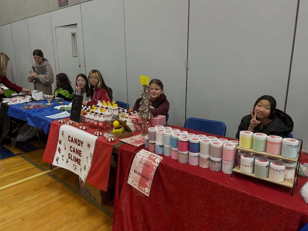 Students pose with their entrepreneurial projects that they sell at the TREPS Marketplace.