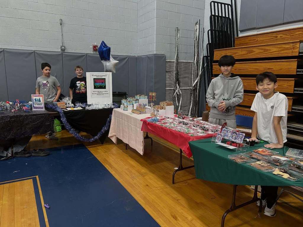 Students pose with their entrepreneurial projects that they sell at the TREPS Marketplace.