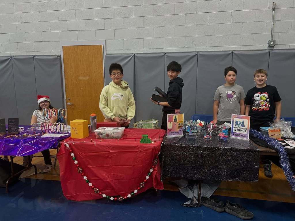 Students pose with their entrepreneurial projects that they sell at the TREPS Marketplace.