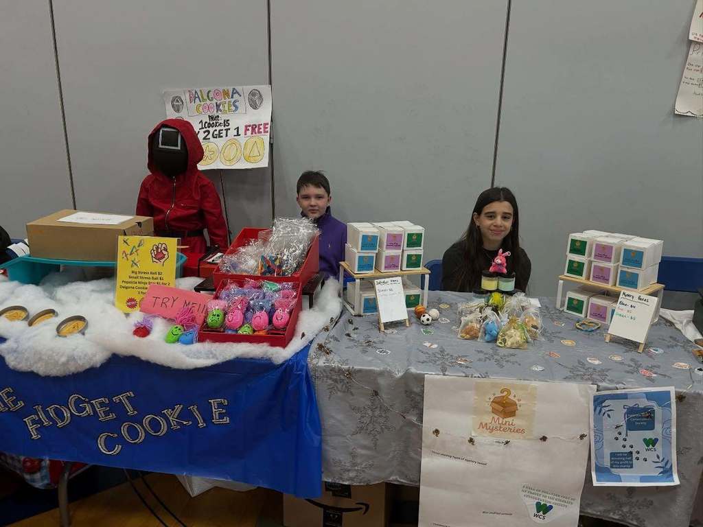 Students pose with their entrepreneurial projects that they sell at the TREPS Marketplace.