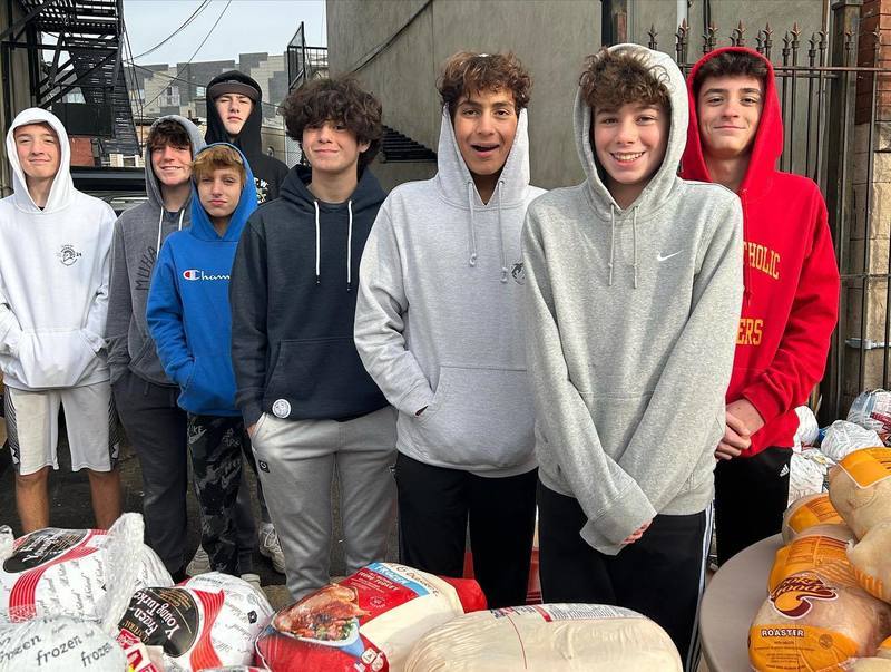 Students in Newark giving out meal bags for thanksgiving