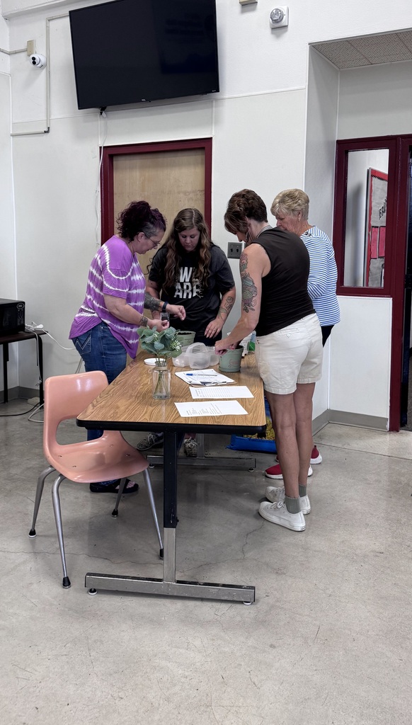 Staff huddled around a potting table.