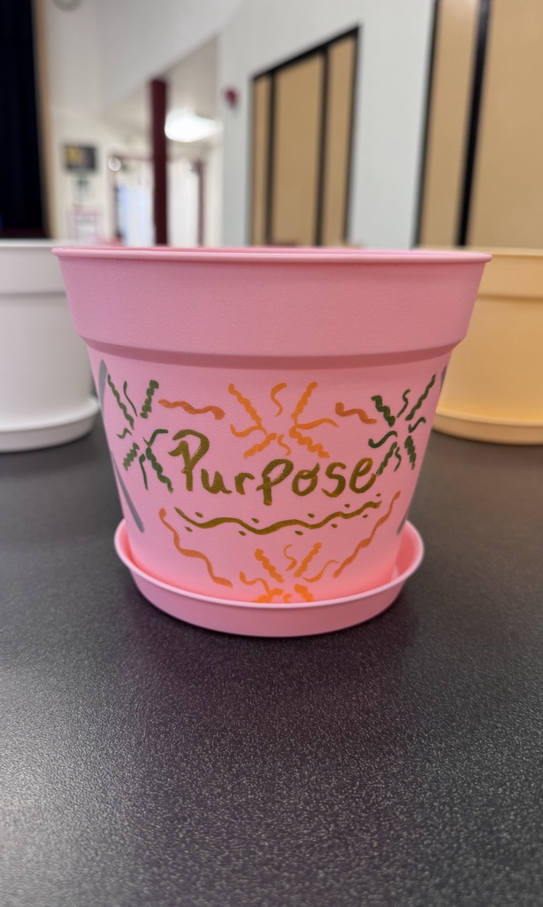 A pot with purpose painted on it 
