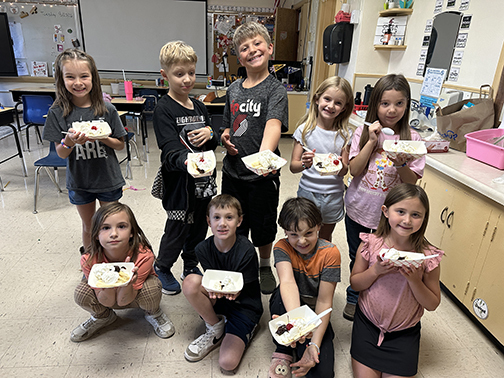 class of kids holding banana splits