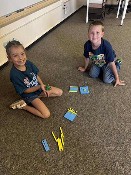 girl and boy with number blocks