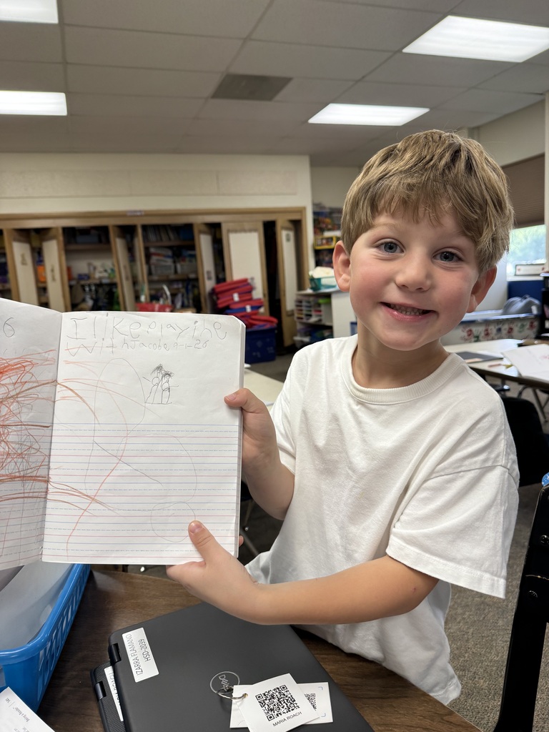a child holding up his drawing