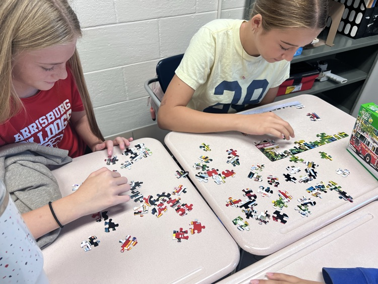students working on jigsaw puzzle