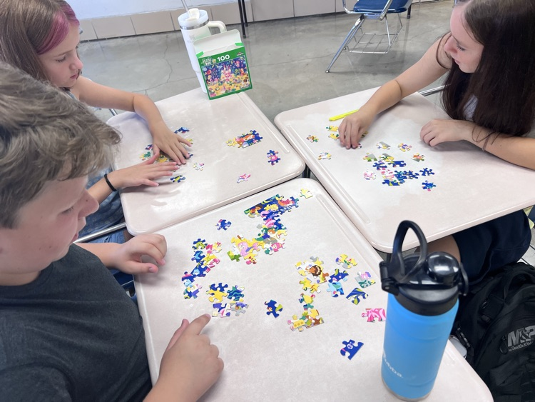 students working on jigsaw puzzle