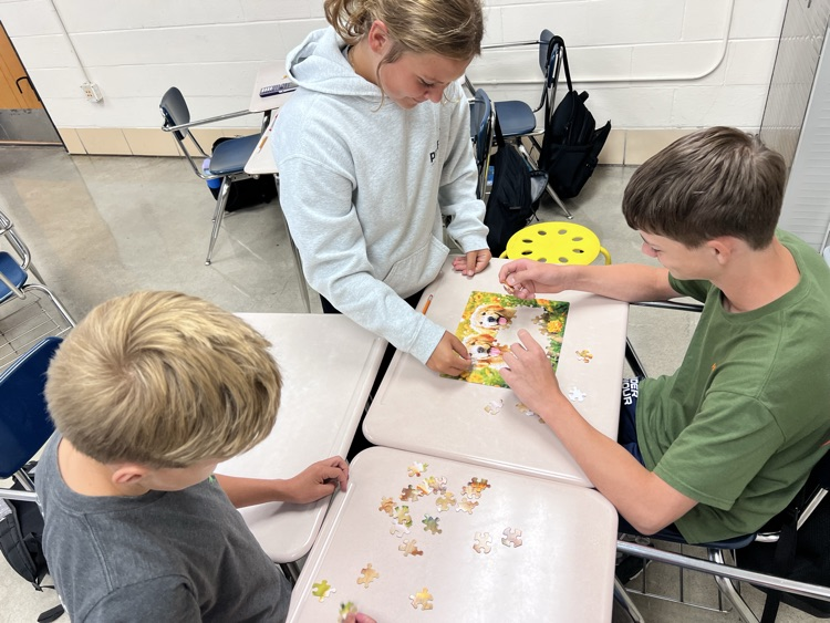 students working on jigsaw puzzle