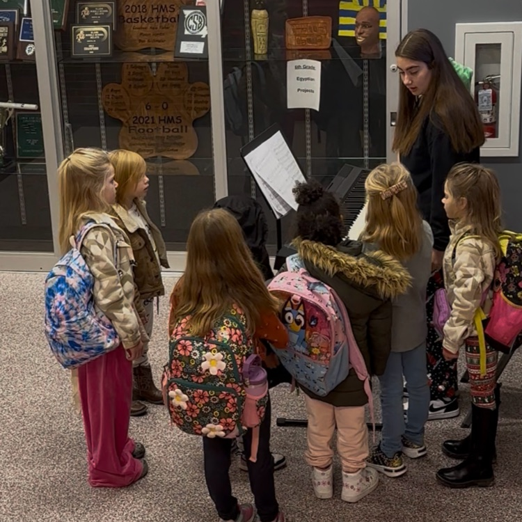 students watching piano player