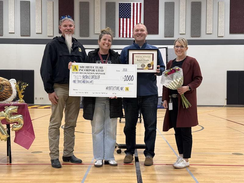 Nichole Drexler receiving a check and flowers 