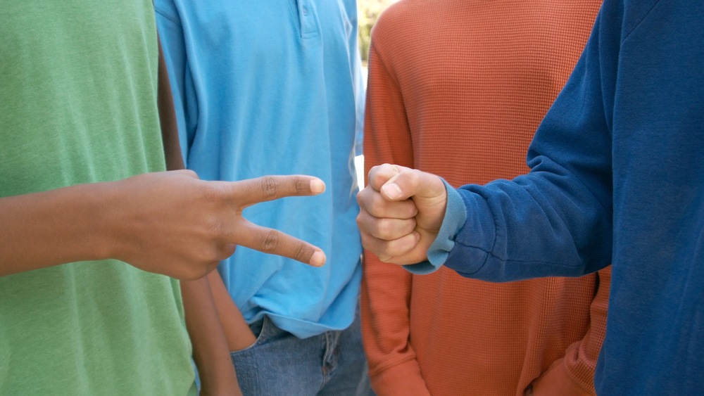 children playing rock, paper, scissors