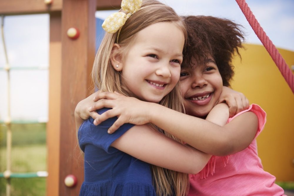 two children hugging each other.