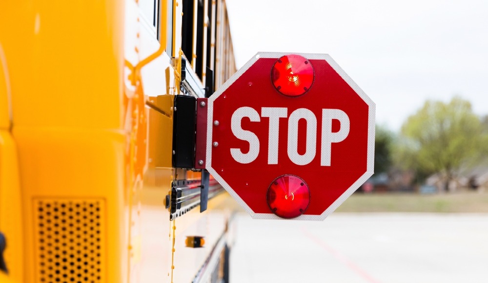school bus with stop sign flashing