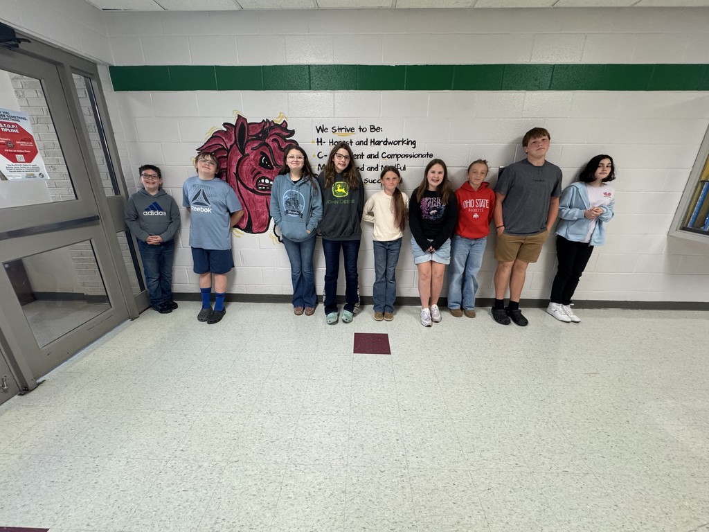 a group of students standing in a hallway