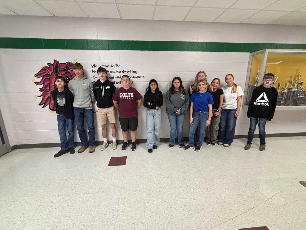 a group of students standing in a hallway