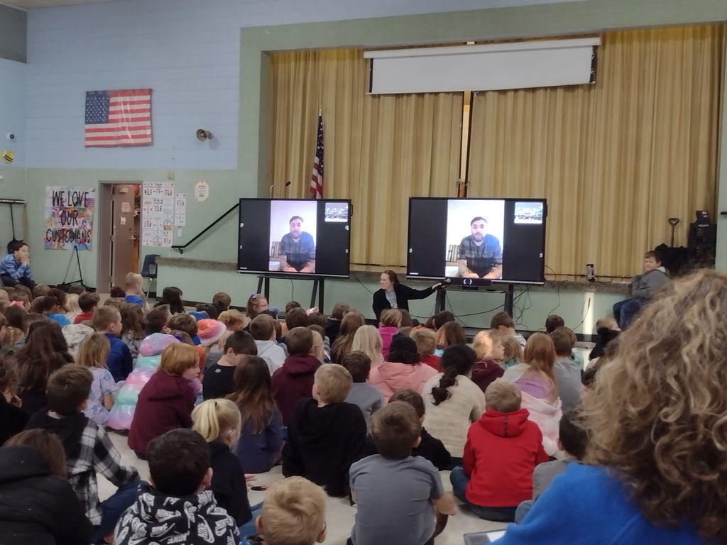 Students watching and chatting with our Veteran