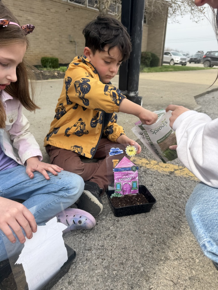 students planting grass seed 