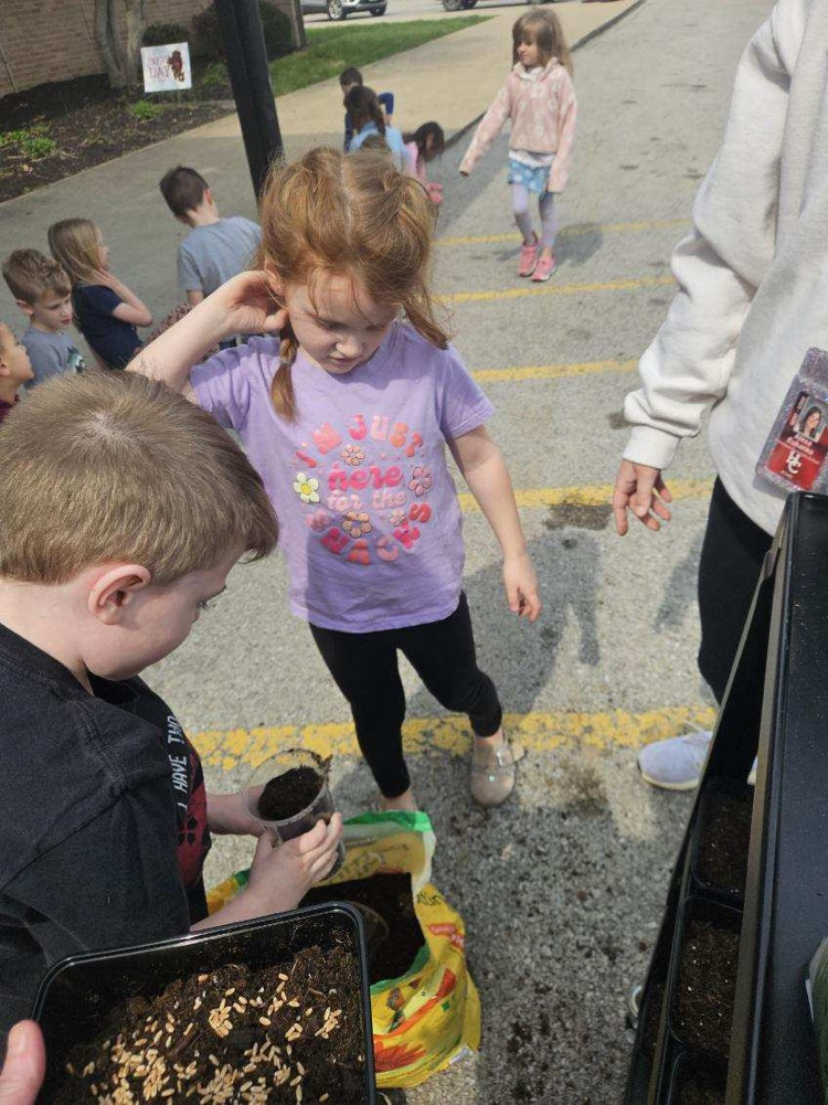 students planting grass seed 