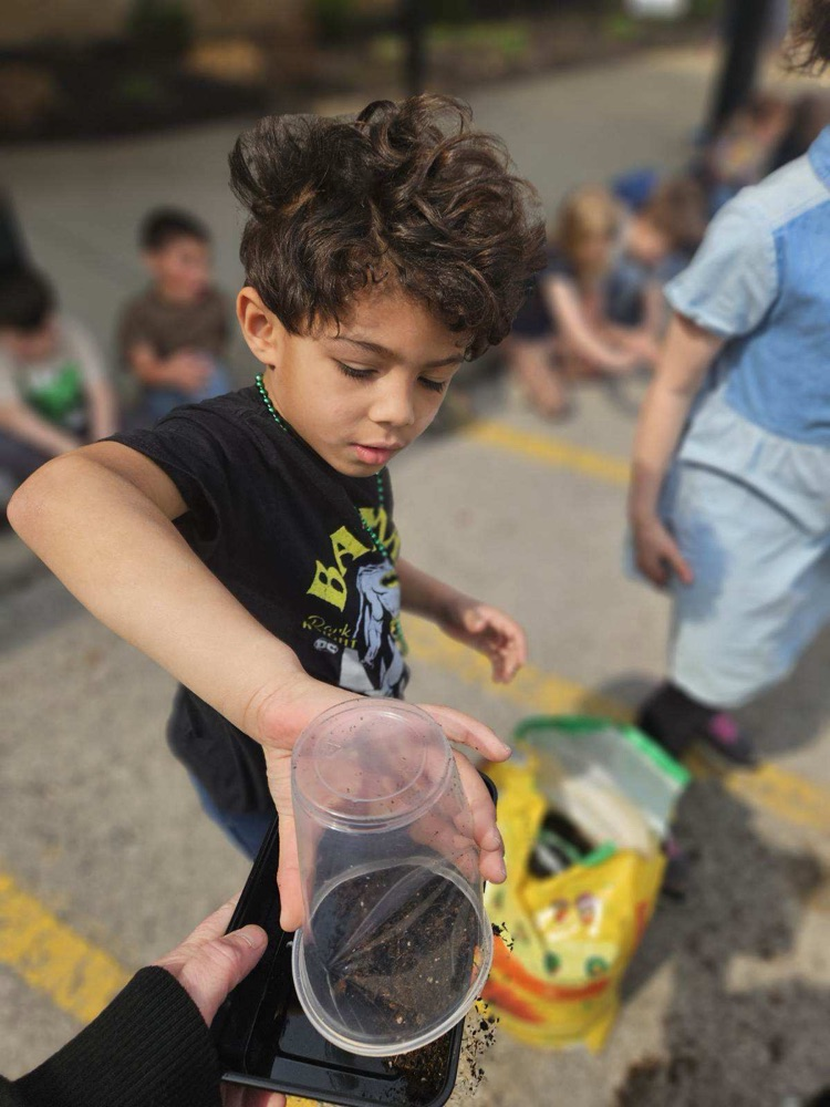 students planting grass seed 