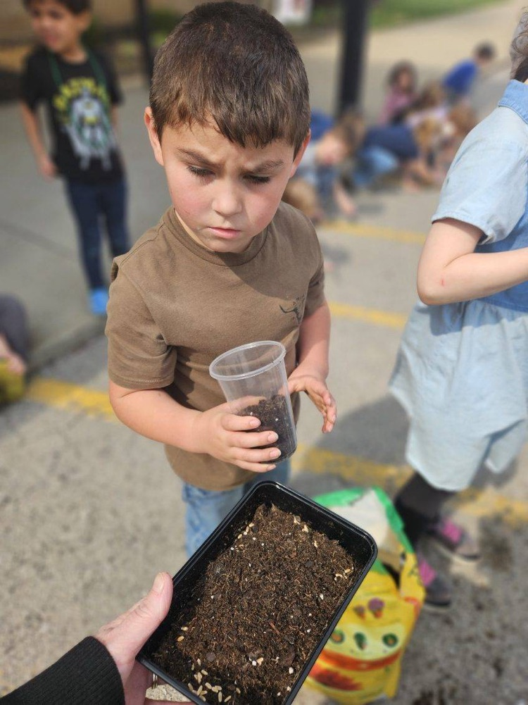 students planting grass seed 