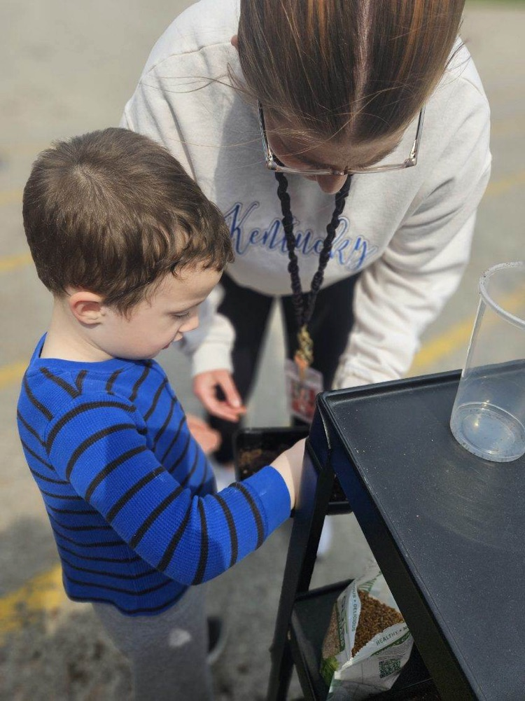 students planting grass seed 