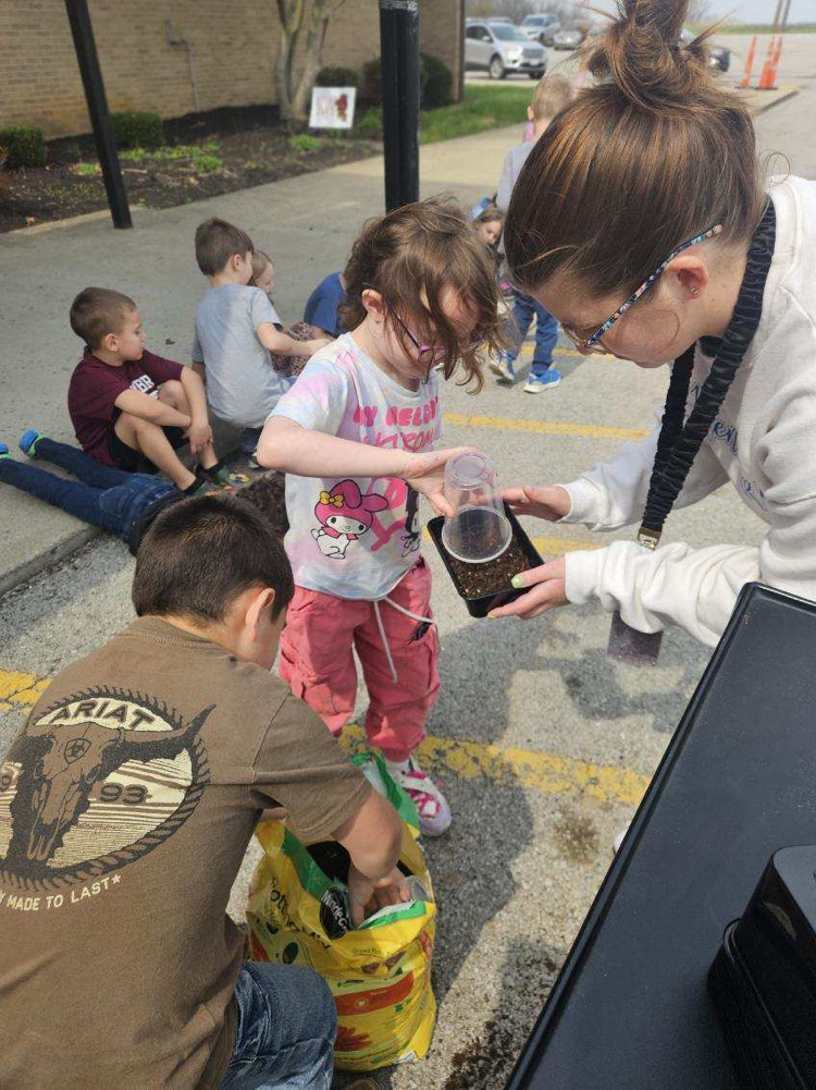 students planting grass seed 
