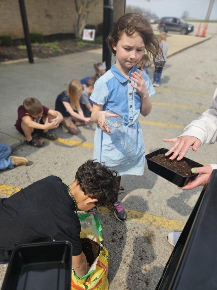 students planting grass seed 