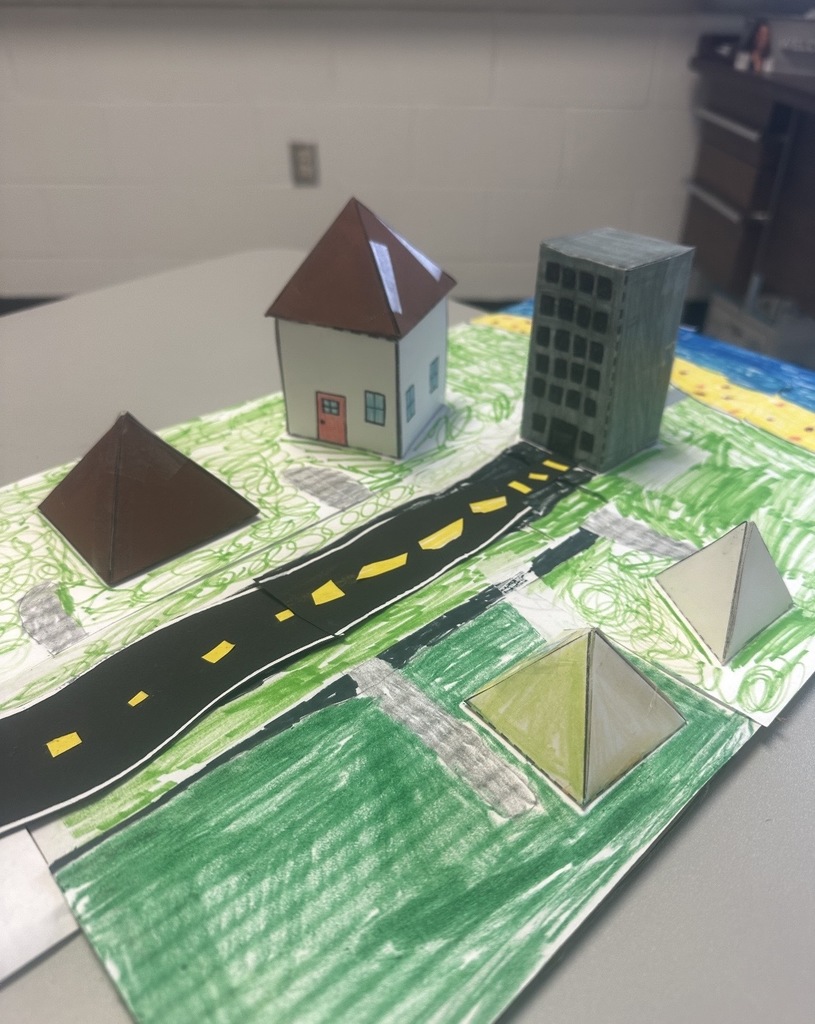 Ms. Woods' class build a city with 3D shapes after learning their characteristics. 