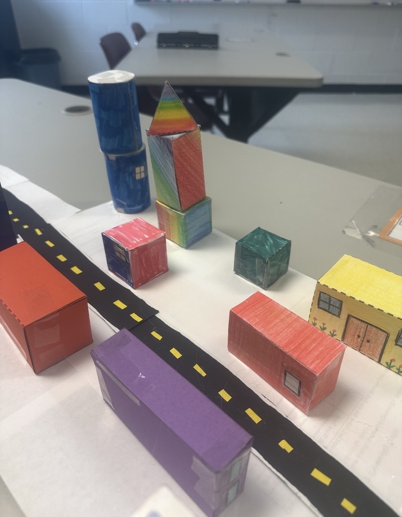 Ms. Woods' class build a city with 3D shapes after learning their characteristics. 