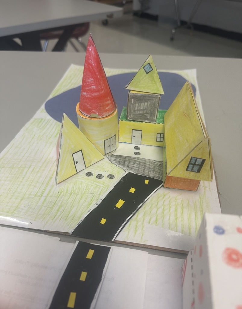 Ms. Woods' class build a city with 3D shapes after learning their characteristics. 