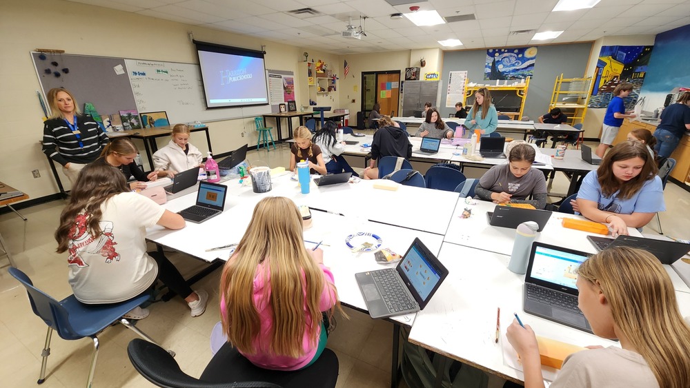 Students at work on art projects in classroom
