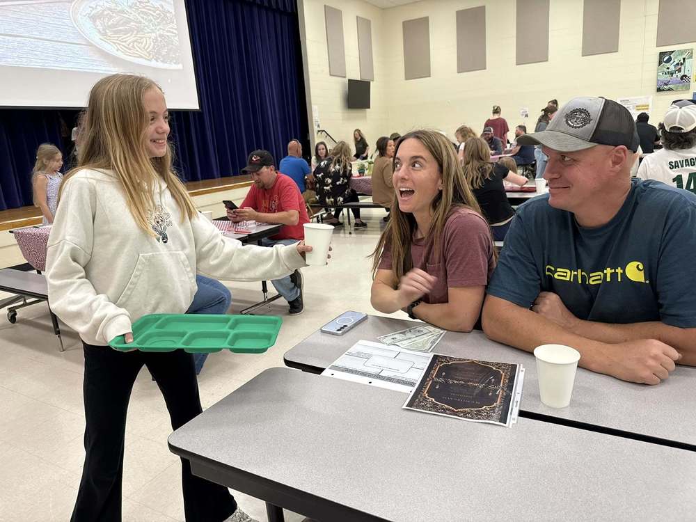 student serving guests at Bug Bistro
