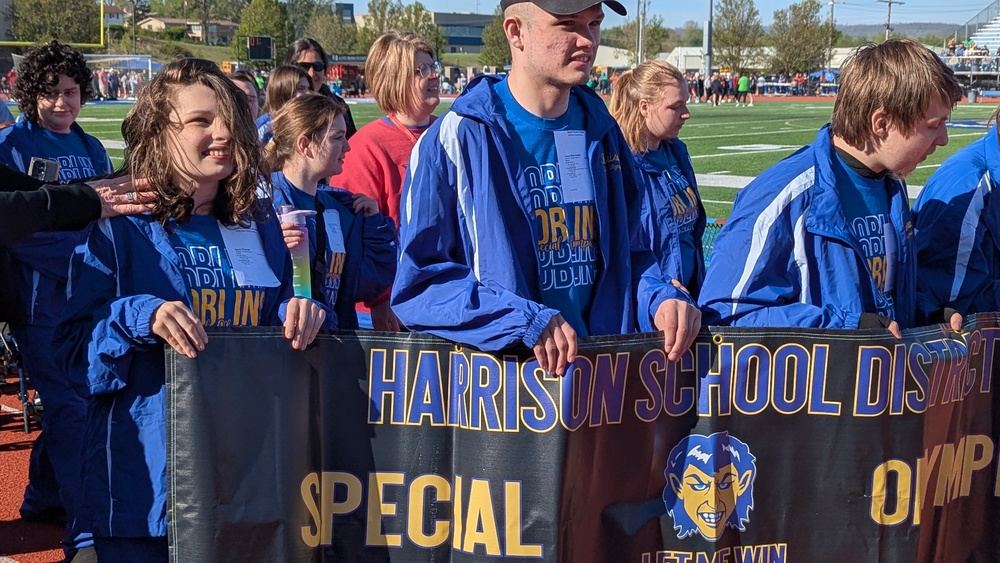 Special Olympians carrying banner