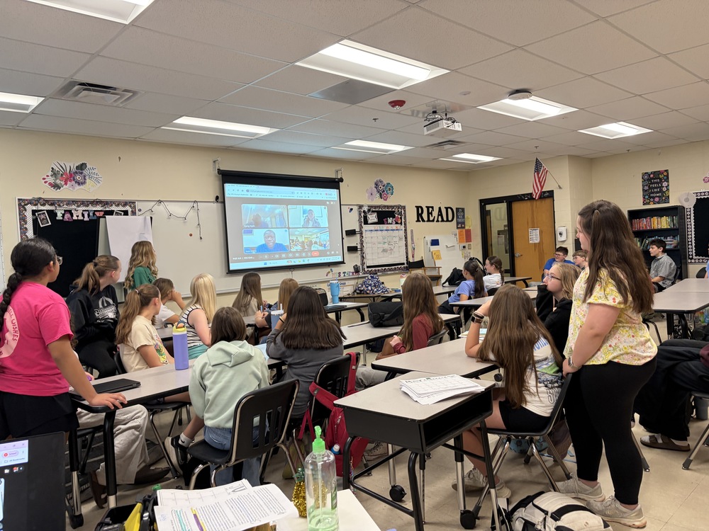Students in classroom on Zoom with water well team