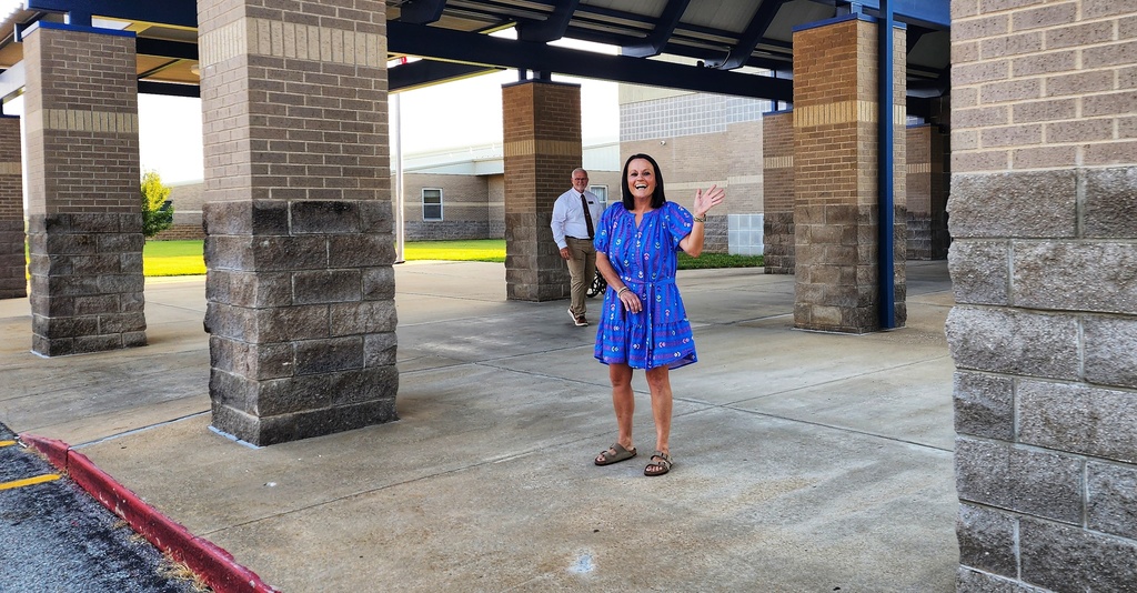 middle school staff greeting students